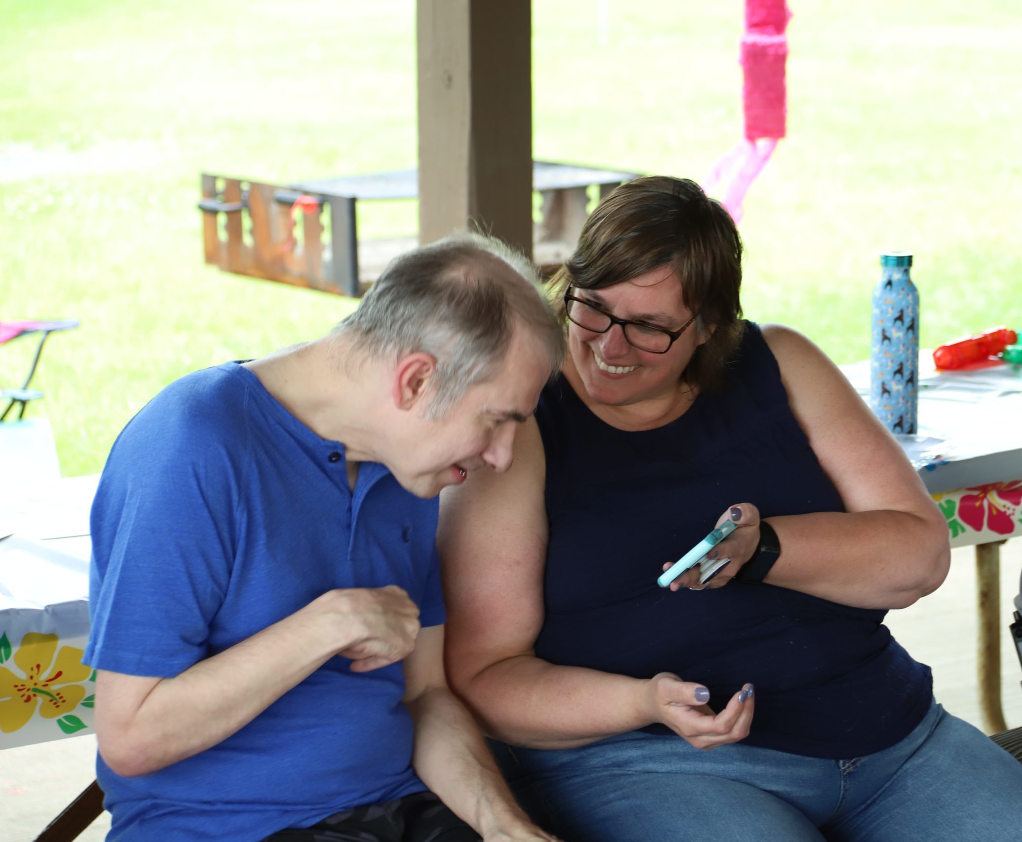 man and woman looking at the cell phone