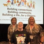 A group of people smiling in front of a presentation at the 2025 Excellence in Life Sharing Awards